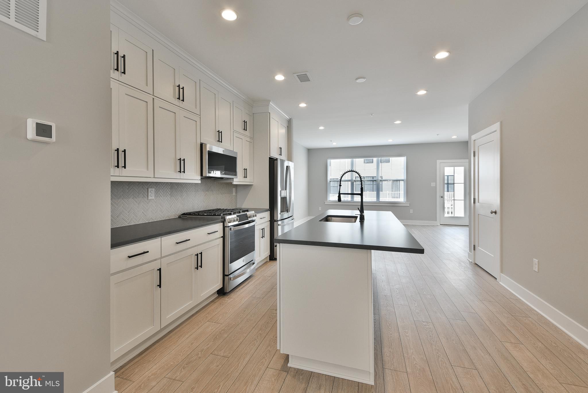 328 Walnut Street Collegeville, PA 19426 - Photo 7 of 35 a large kitchen with cabinets wooden floor and stainless steel appliances