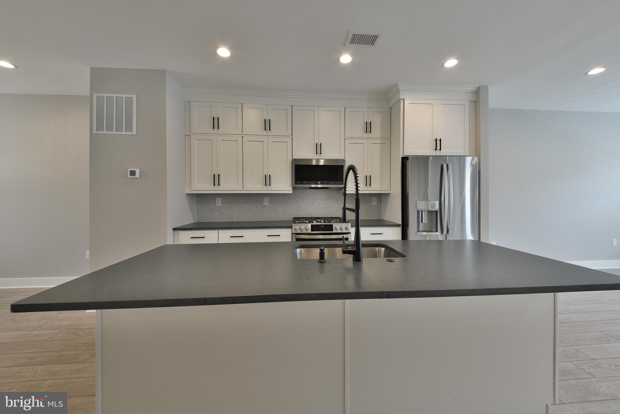 328 Walnut Street Collegeville, PA 19426 - Photo 8 of 35 a kitchen with stainless steel appliances granite countertop a sink refrigerator and cabinets