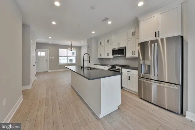 a kitchen with stainless steel appliances a stove and a microwave