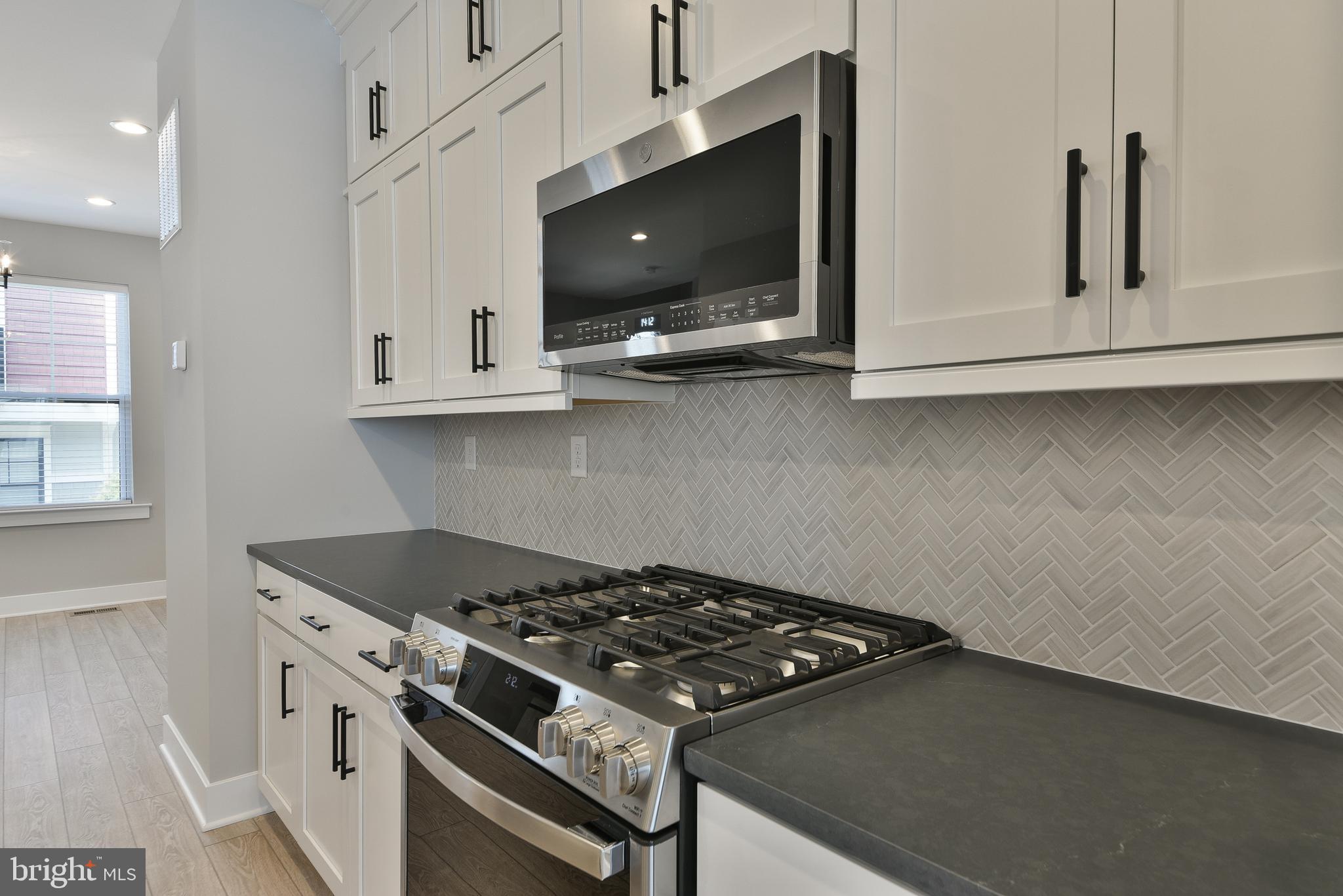328 Walnut Street Collegeville, PA 19426 - Photo 10 of 35 a kitchen with stainless steel appliances a stove and a microwave