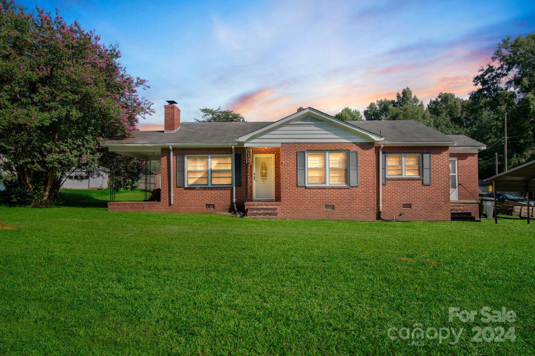 1209 White Store Road Wadesboro, NC 28170 - Photo 1 of 30 a front view of a house with a garden