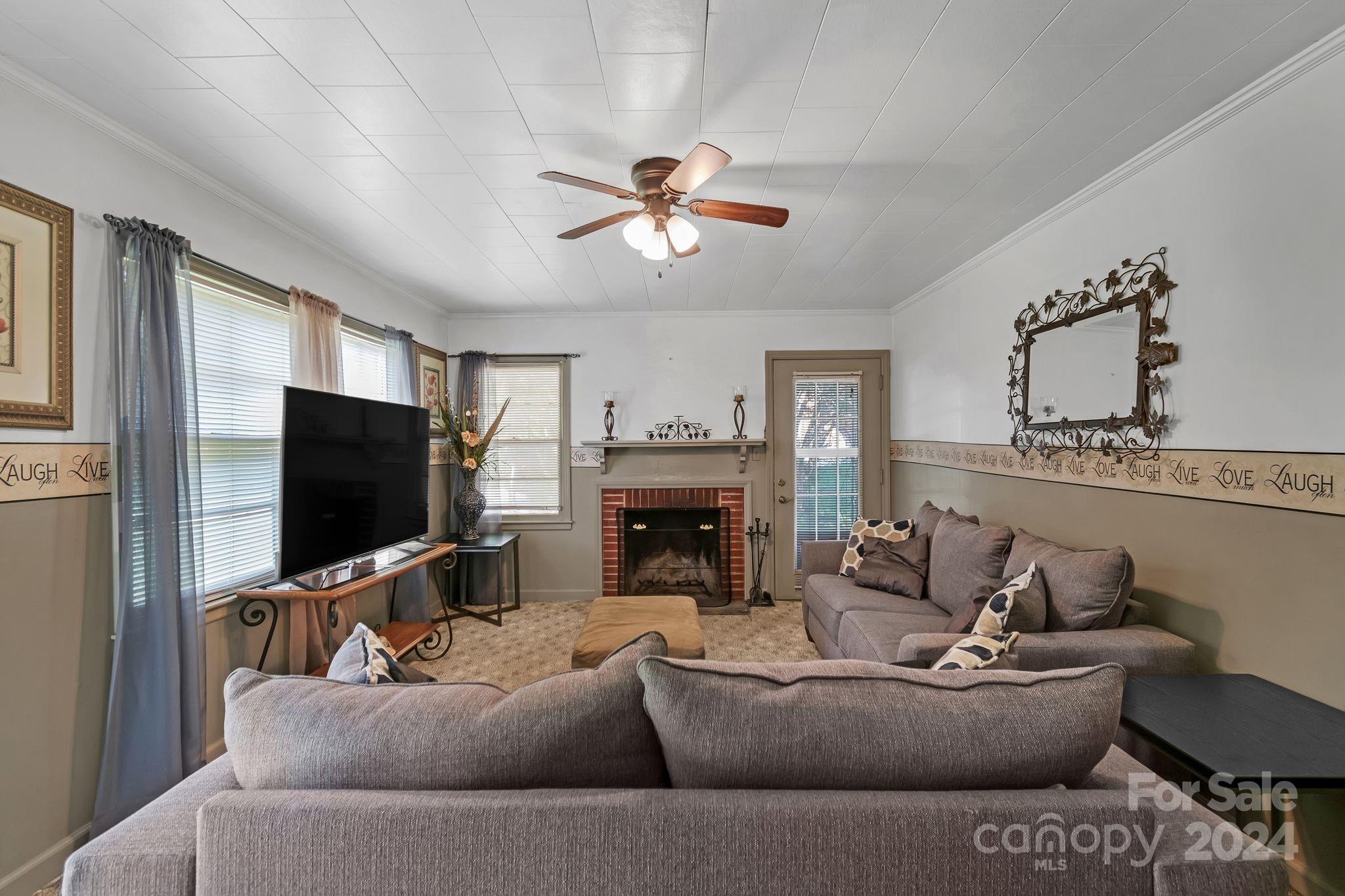 1209 White Store Road Wadesboro, NC 28170 - Photo 5 of 30 a living room with furniture a fireplace and a flat screen tv