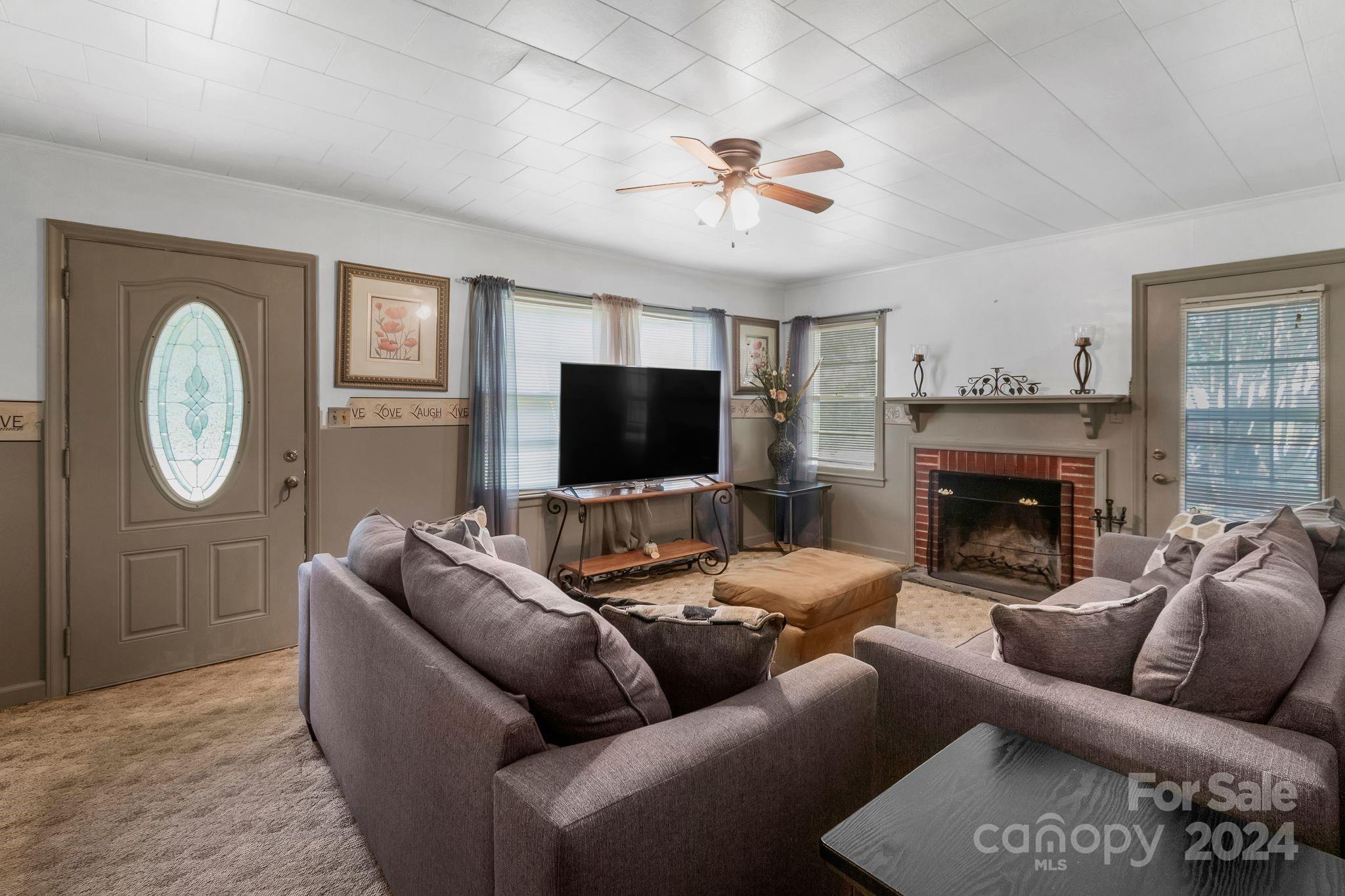 1209 White Store Road Wadesboro, NC 28170 - Photo 6 of 30 a living room with furniture a flat screen tv and a fireplace