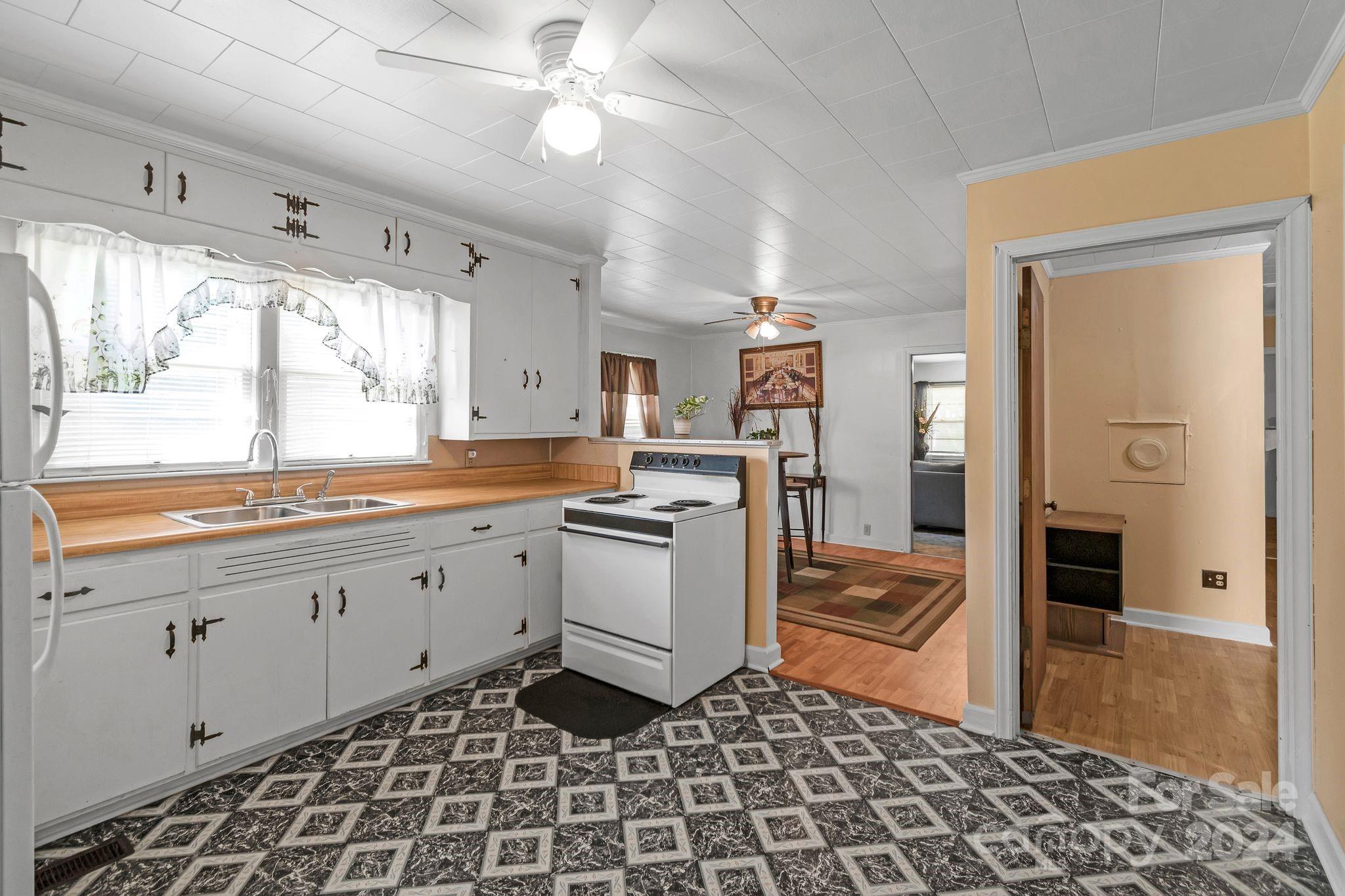 1209 White Store Road Wadesboro, NC 28170 - Photo 10 of 30 a kitchen with a stove a sink and a refrigerator
