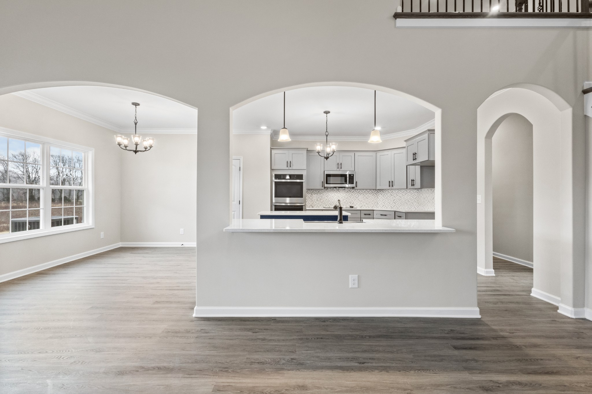 1173 Juniper Pass Clarksville, TN 37043 - Photo 12 of 51 a large kitchen with stainless steel appliances a large counter top a fireplace and a chandelier