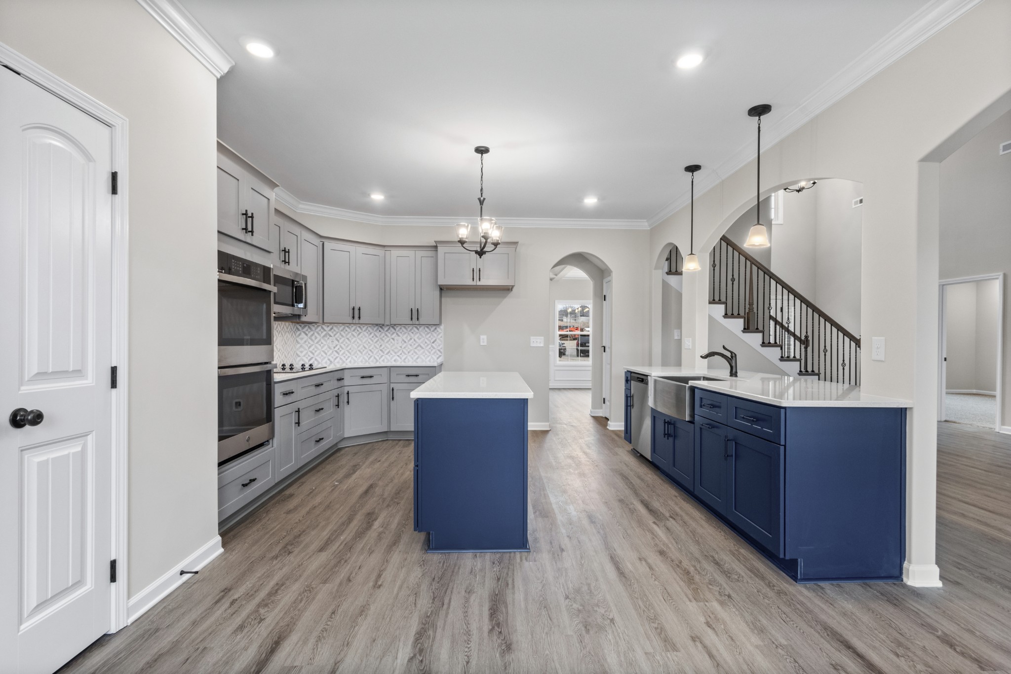 1173 Juniper Pass Clarksville, TN 37043 - Photo 14 of 51 a large kitchen with stainless steel appliances kitchen island granite countertop a large counter top and wooden floors