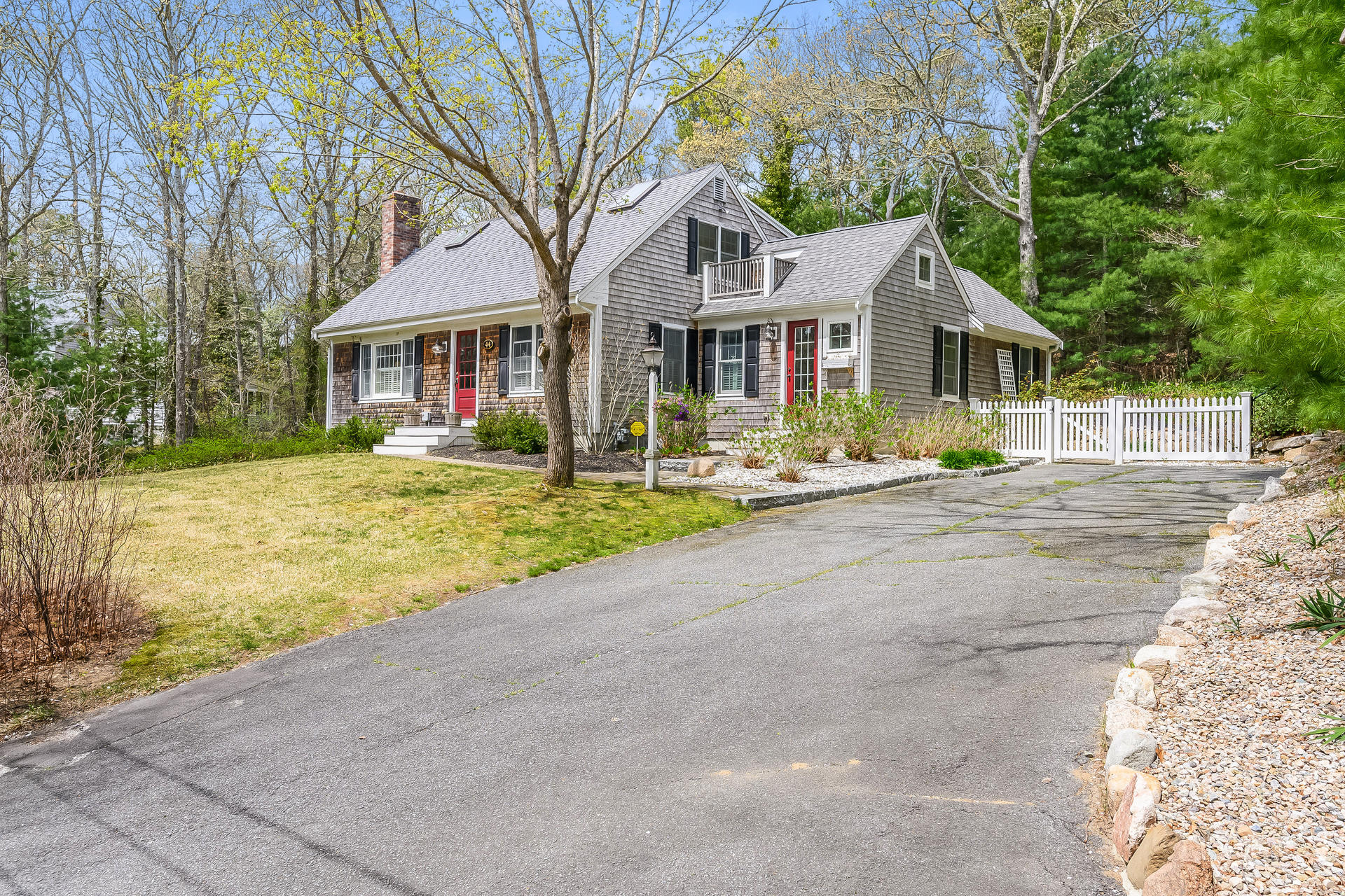 44 Cedarwood Road Cotuit, MA 02635 - Photo 1 of 19 a front view of a house with a yard