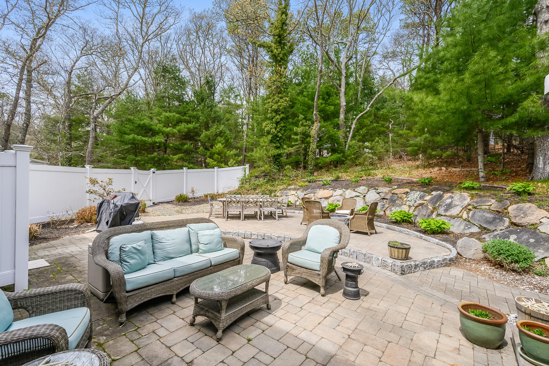 44 Cedarwood Road Cotuit, MA 02635 - Photo 18 of 19 a view of a patio with couches and potted plants