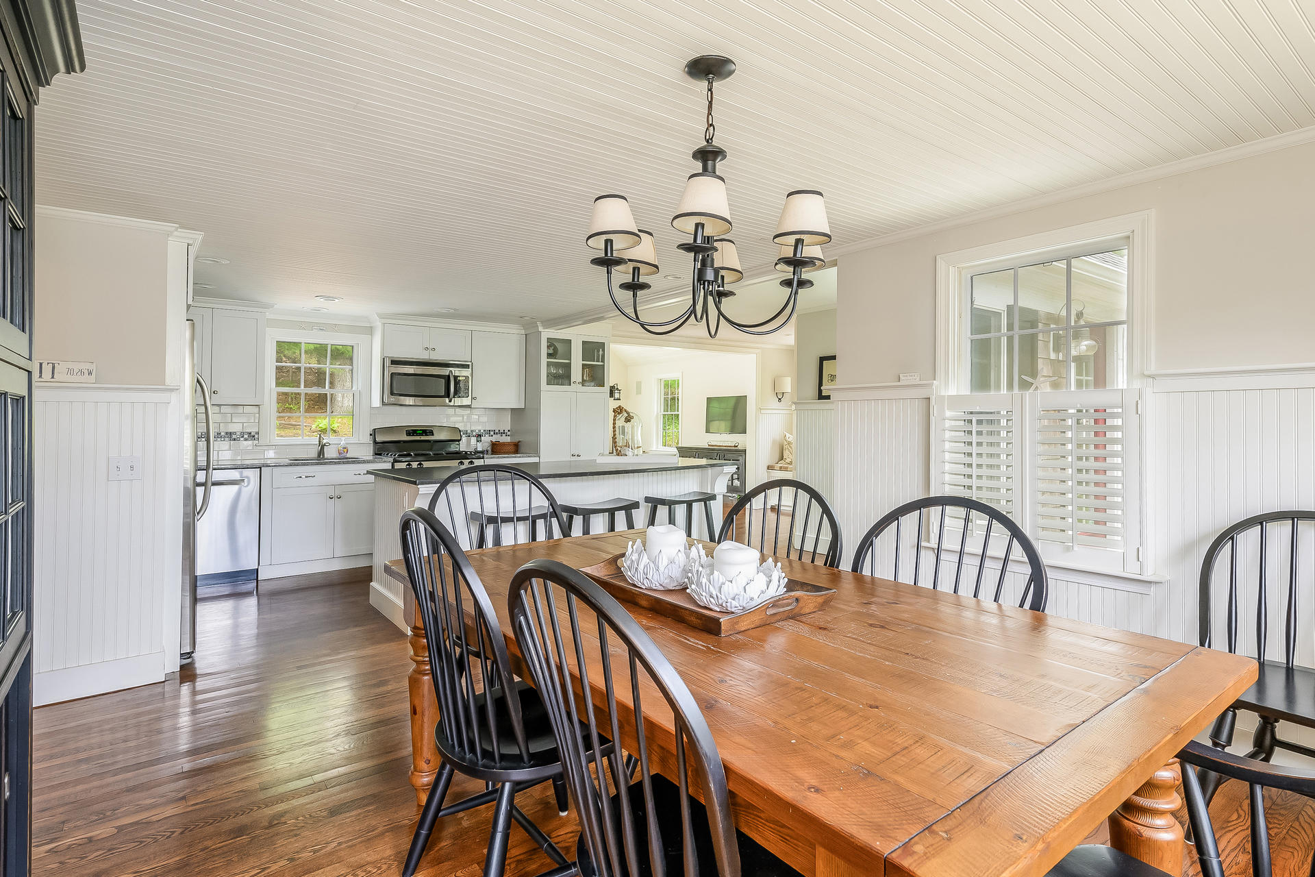 44 Cedarwood Road Cotuit, MA 02635 - Photo 5 of 19 a dining room with furniture a chandelier and wooden floor