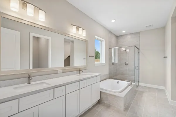 a spacious bathroom with a double vanity sink mirror double and shower