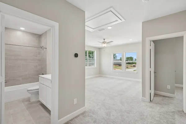 a bathroom with a granite countertop sink a toilet and shower