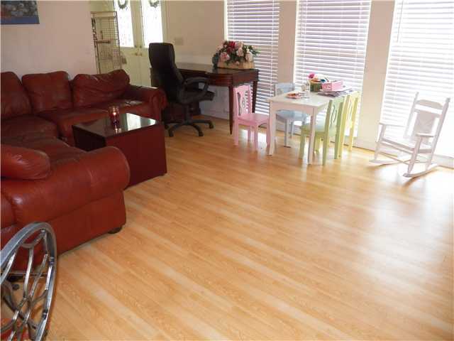 780 Southwest Ancona Road Port St. Lucie, FL 34953 - Photo 2 of 7 a living room with furniture a dining table and with wooden floor
