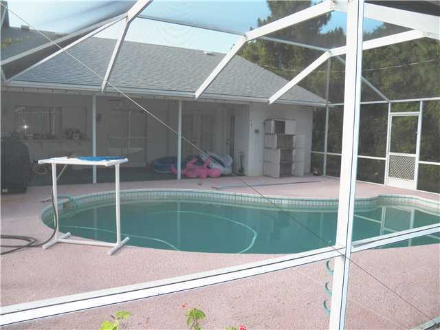 780 Southwest Ancona Road Port St. Lucie, FL 34953 - Photo 7 of 7 a view of a wooden deck with a yard