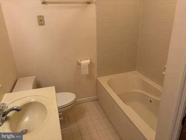 a bathroom with a sink and mirror with toilet