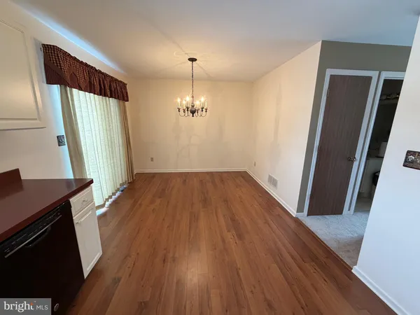 a view of a room with wooden floor and staircase