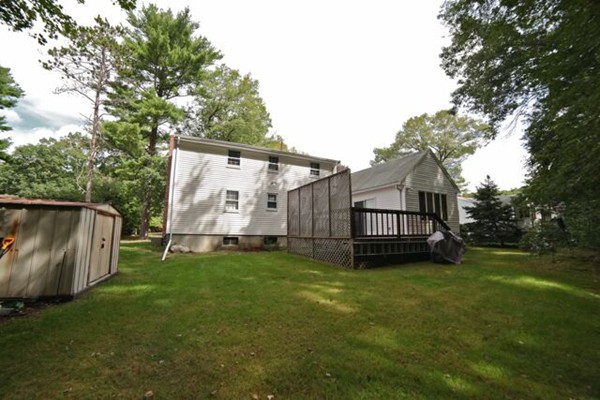 99 Spallus Road Stoughton, MA 02072 - Photo 14 of 14 a view of a backyard with a garden and entertaining space