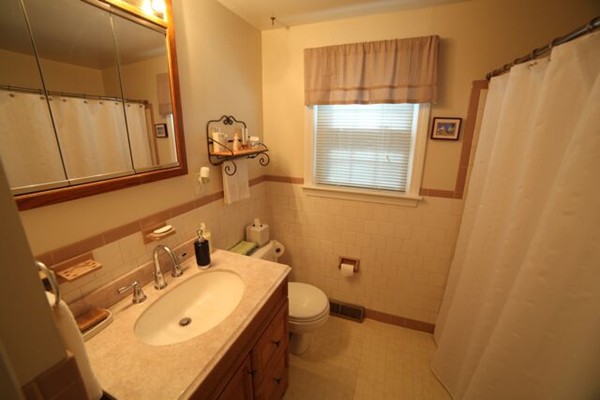 99 Spallus Road Stoughton, MA 02072 - Photo 6 of 14 a bathroom with a sink and mirror with window
