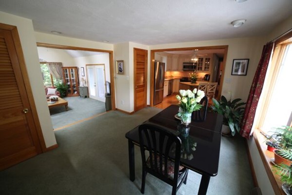 99 Spallus Road Stoughton, MA 02072 - Photo 9 of 14 a dining room with furniture potted plants and wooden floor