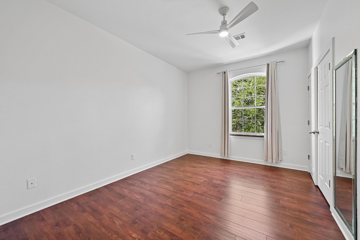 2705 Bonnie Road, Unit A Austin, TX 78703 - Photo 11 of 18 a view of an empty room with wooden floor and a window
