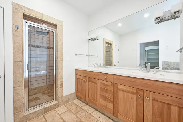 a bathroom with double sink and a mirror