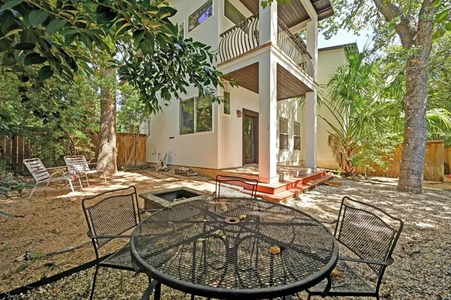 a view of a house with backyard sitting area and backyard
