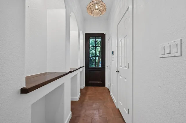 a hallway with windows and wooden floor