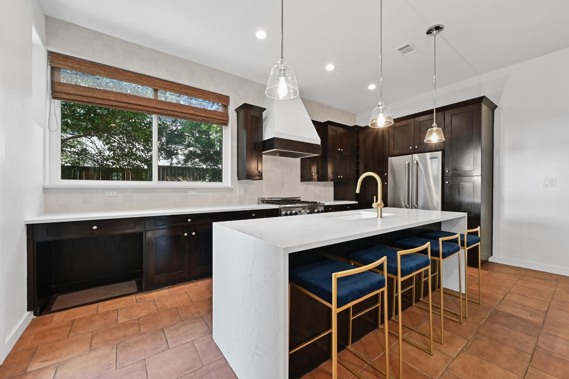 2705 Bonnie Road, Unit A Austin, TX 78703 - Photo 5 of 18 a kitchen with stainless steel appliances granite countertop a sink a stove and a refrigerator
