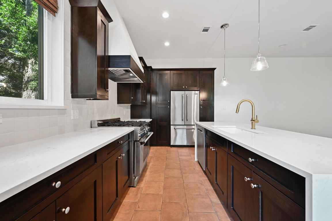 2705 Bonnie Road, Unit A Austin, TX 78703 - Photo 6 of 18 a kitchen with stainless steel appliances a sink stove and cabinets