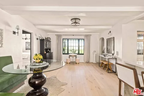 a living room with furniture and a dining table