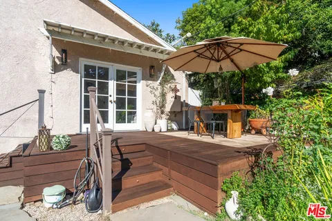 a couple of potted plants in front of a house