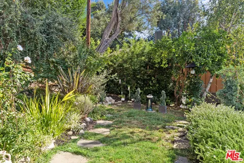 a view of a palm trees front of house