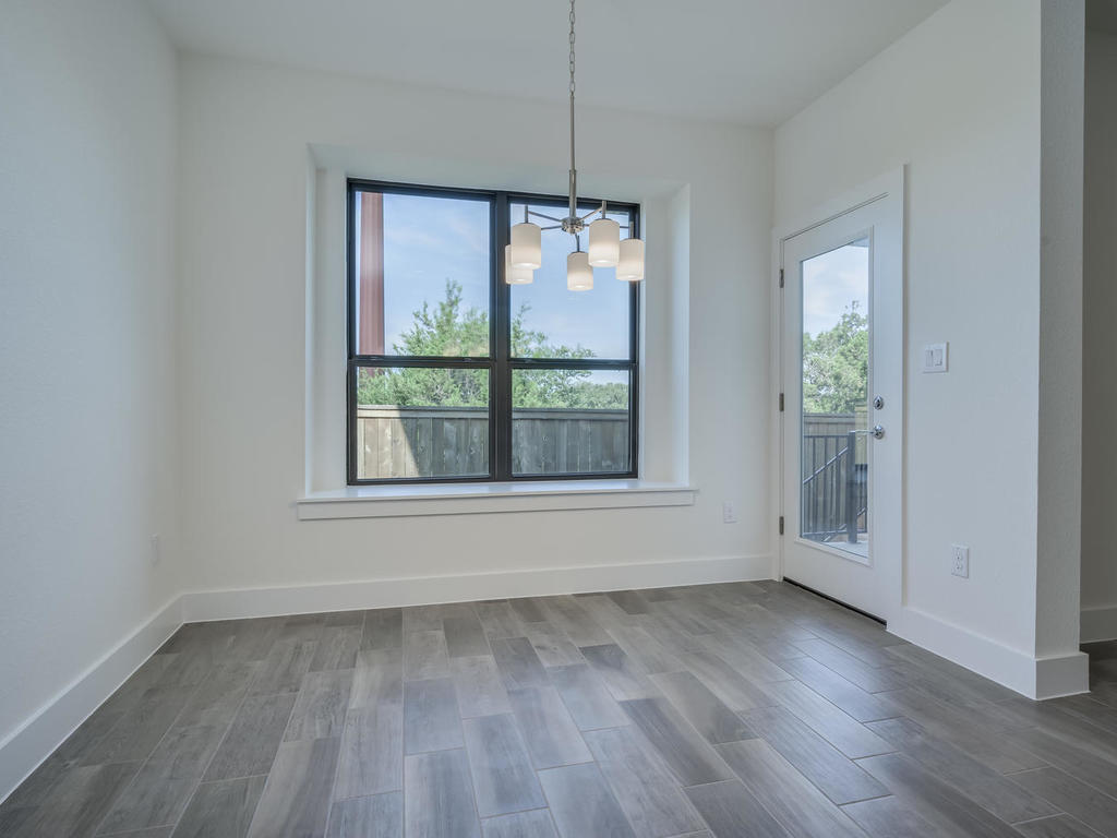 12327 Maypole Bend Austin, TX 78717 - Photo 17 of 30 an empty room with wooden floor and windows