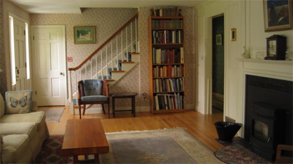75 Amherst Road Leverett, MA 01054 - Photo 3 of 22 a living room with furniture a rug and a book shelf
