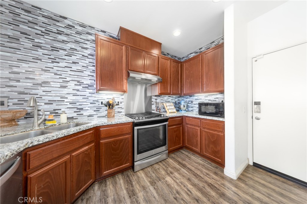 12068 Preston Street Grand Terrace, CA 92313 - Photo 13 of 34 a kitchen with stainless steel appliances granite countertop a sink stove and refrigerator