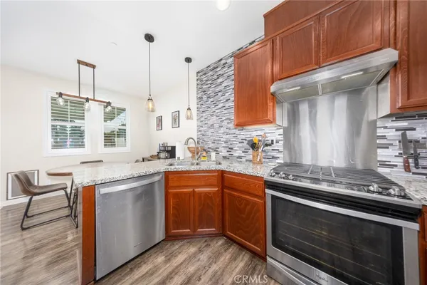 a kitchen with stainless steel appliances granite countertop a stove and a sink
