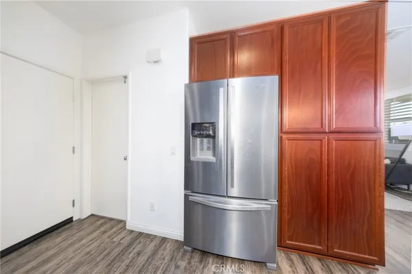 a metallic refrigerator freezer sitting in a kitchen