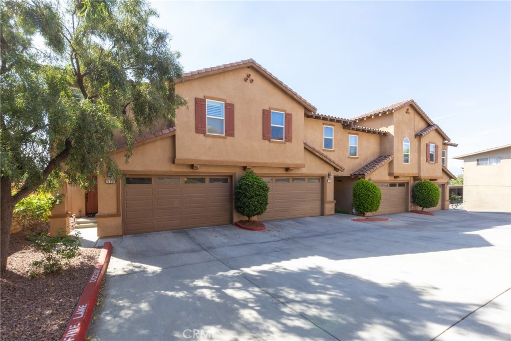 12068 Preston Street Grand Terrace, CA 92313 - Photo 2 of 34 a front view of a house with a yard and garage