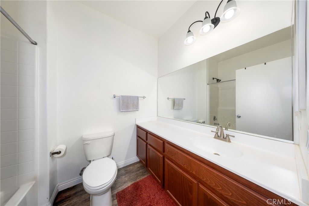 12068 Preston Street Grand Terrace, CA 92313 - Photo 21 of 34 a bathroom with a sink a toilet a mirror and shower