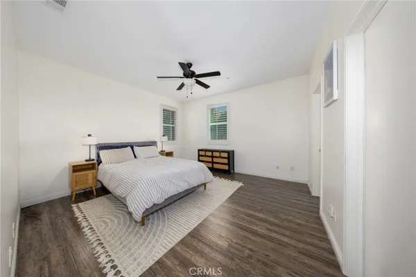 a spacious bedroom with a bed and a chandelier