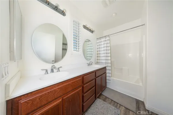 a bathroom with a double vanity sink and a mirror