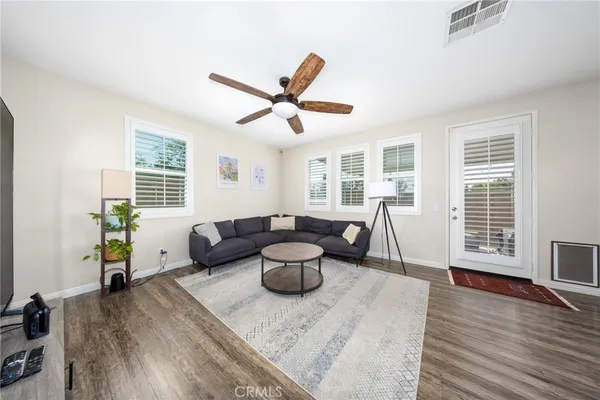 a living room with furniture and wooden floor