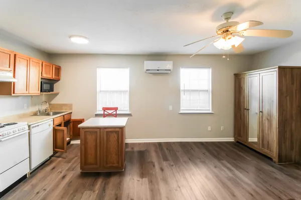 a view of a room with wooden floor and window