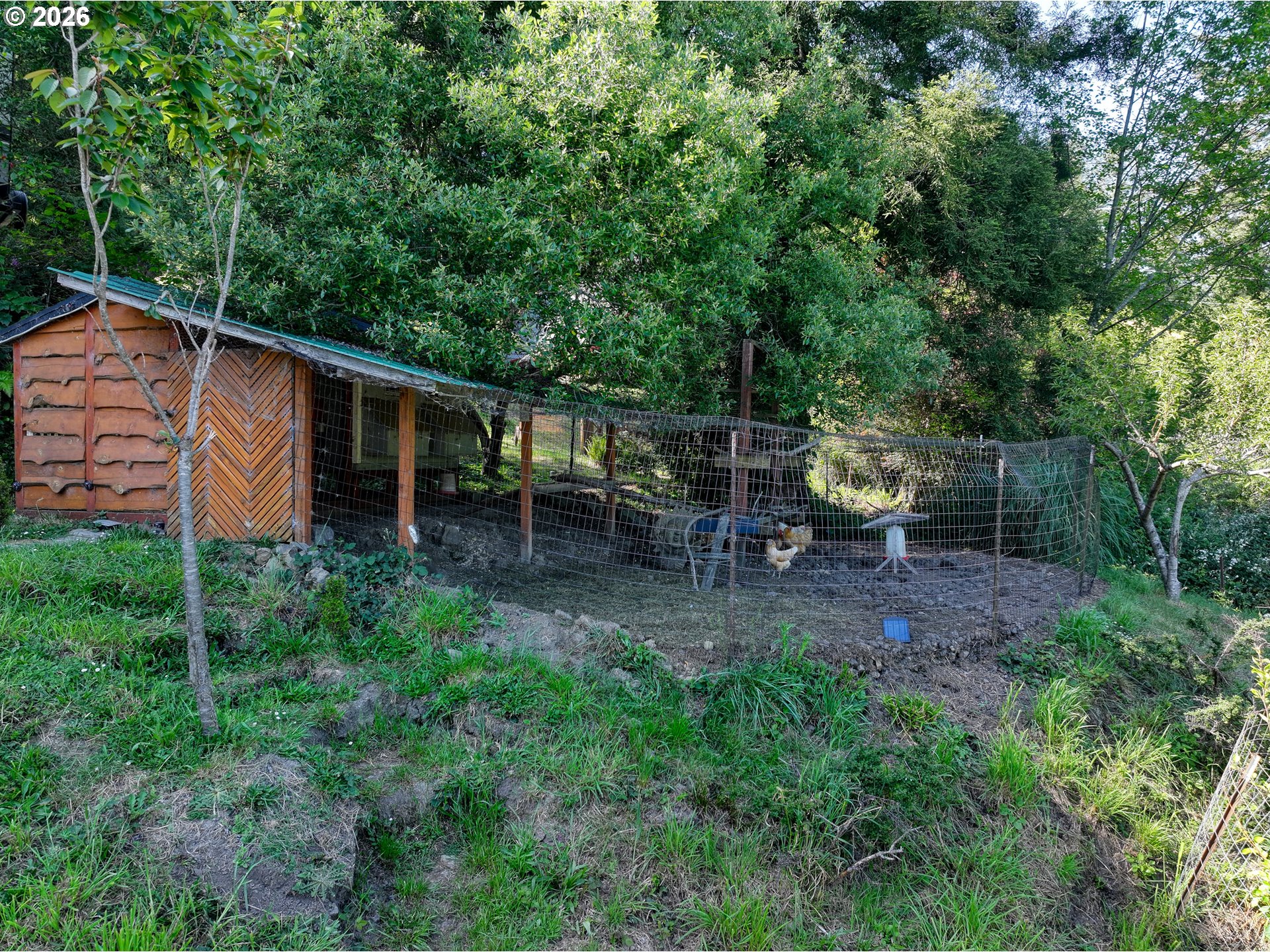 16711 Thompson Road Brookings, OR 97415 - Photo 44 of 45 a backyard of a house with table and chairs