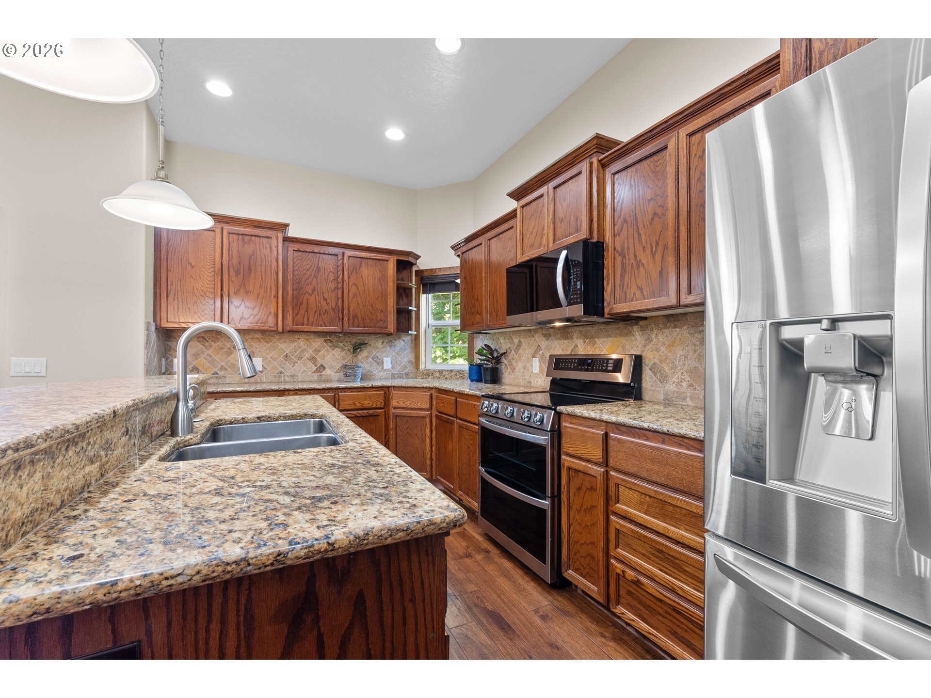 16711 Thompson Road Brookings, OR 97415 - Photo 10 of 45 a kitchen with kitchen island granite countertop a sink stove and refrigerator