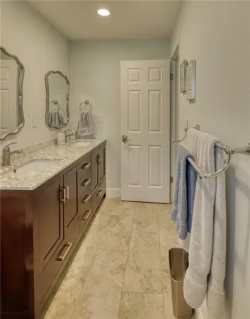 a bathroom with a double vanity sink and mirror