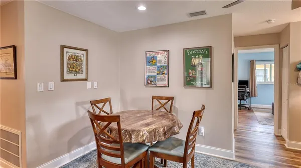 a dining room with furniture and wooden floor