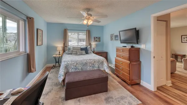 a bedroom with a bed and a flat screen tv