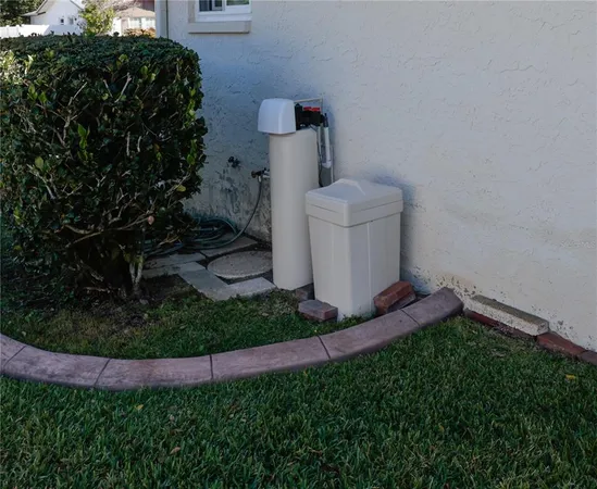 a view of a backyard with wooden fence