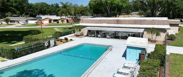 an aerial view of a house with a garden and swimming pool