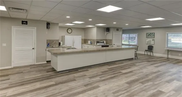 a large white kitchen with a large window